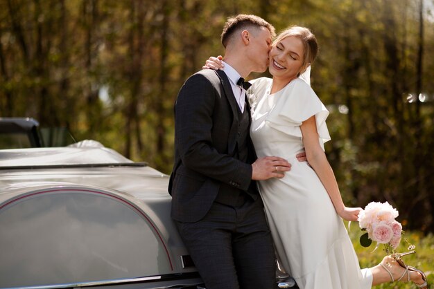 Just married couple with their car