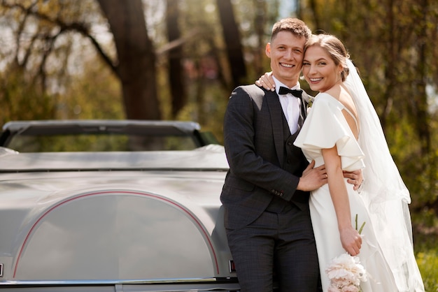 Just married couple with their car