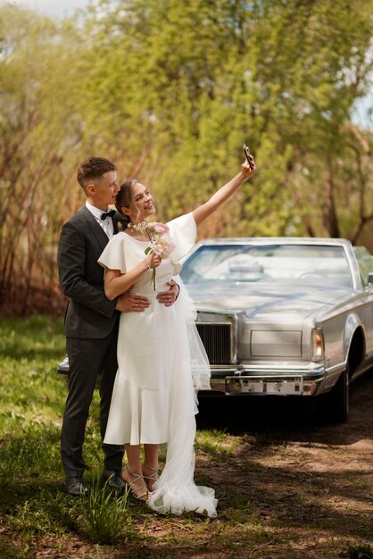 Just married couple with their car