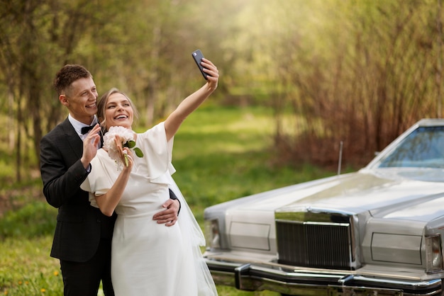 Free photo just married couple with their car