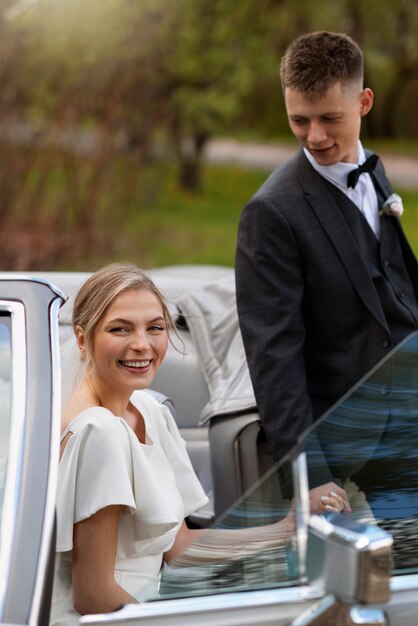 Just married couple with their car