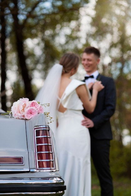 Just married couple with their car