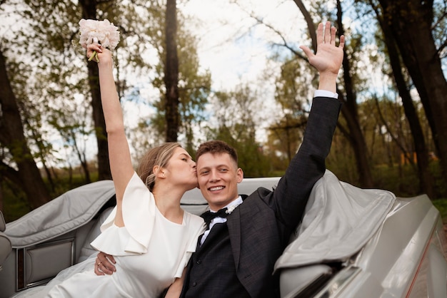 Free photo just married couple with their car