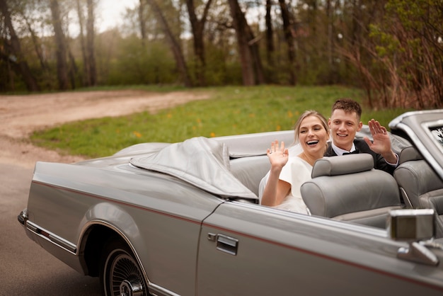 Just married couple with their car