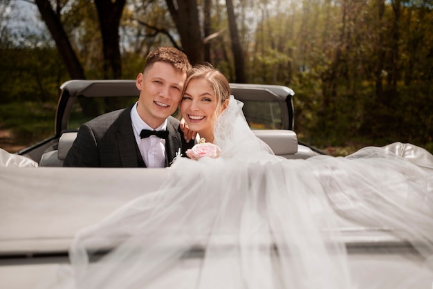 Just married couple with their car