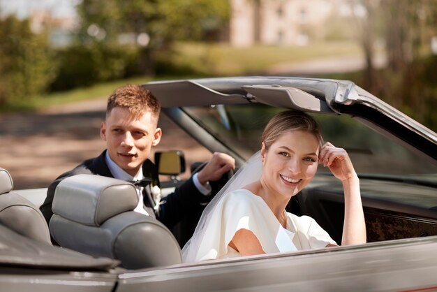 Just married couple with their car