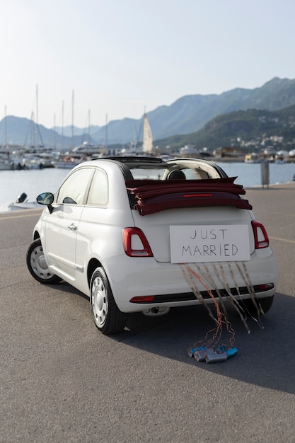 Free photo just married little car on the harbor