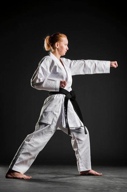 Karate girl practicing side view