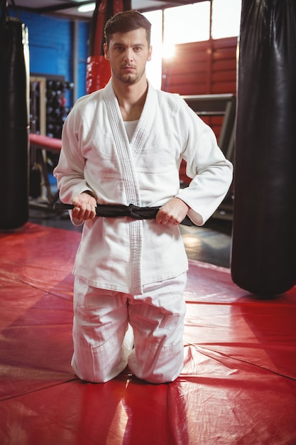 Karate player tying his belt