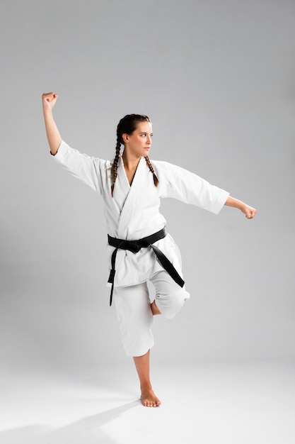 Karate woman in action isolated in white background