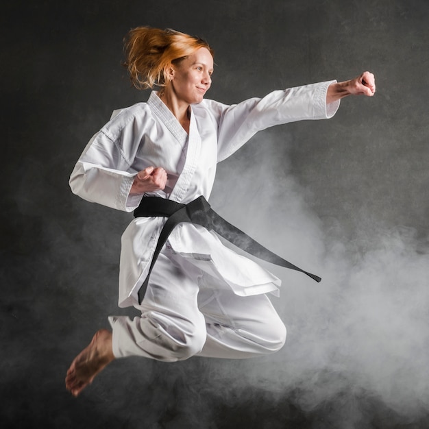 Free photo karate woman jumping full shot