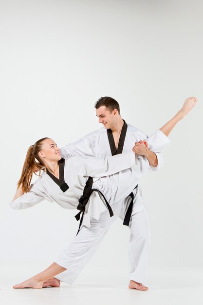 The karate woman and man with black belts