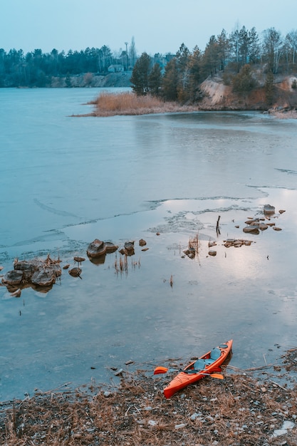 Free Photo kayak lies on a wild beach of a wild lake