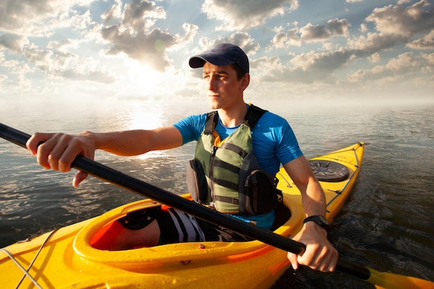 Kayaking Man paddling a kayak Canoeing paddling