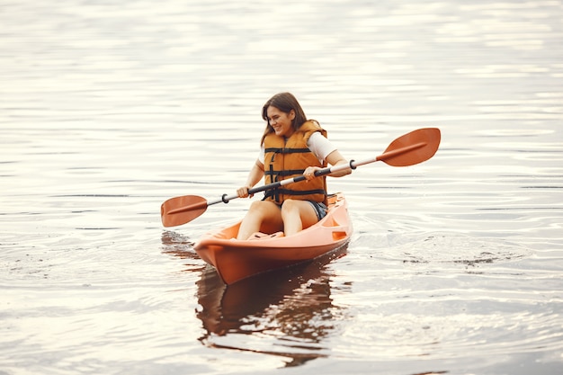 Free photo kayaking. a woman in a kayak. girl paddling in the water.