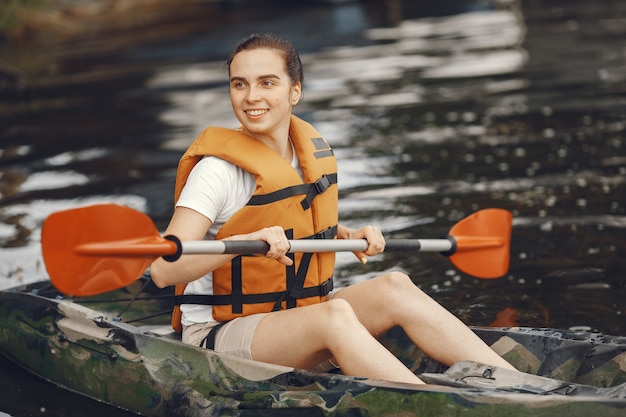 Free photo kayaking. a woman in a kayak. girl paddling in the water.