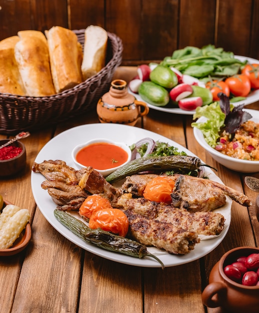 Kebab platter with chicken vegetables lamb tikka and lula kebabs vertical