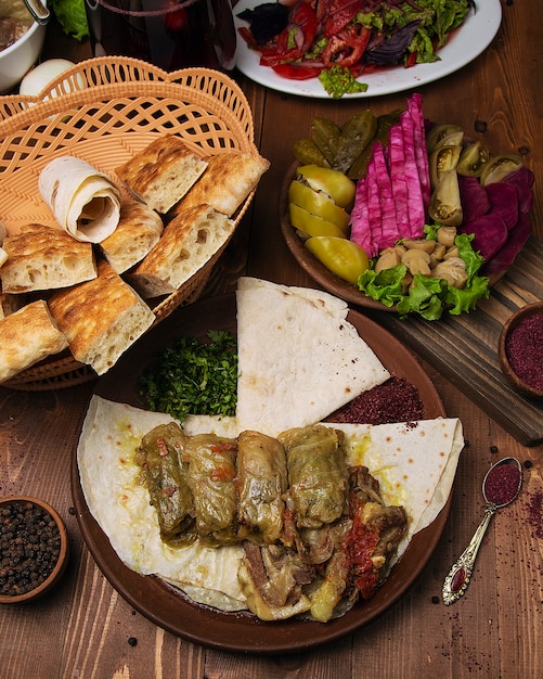 Kelem dolmasi, cabbage leaves stuffed with meat and rice, with beef stew with vegetables in lavash.