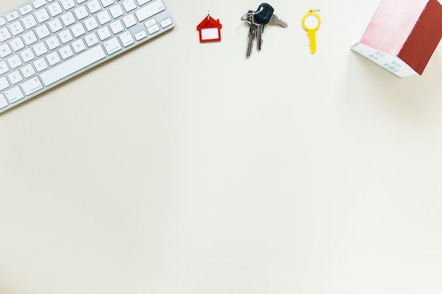 Keyboard with keys and house model on white background