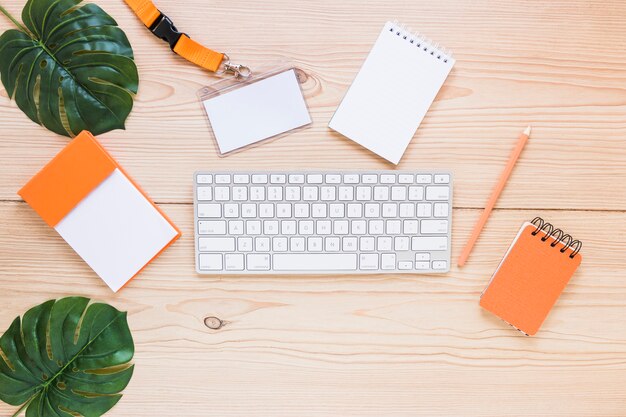 Keyboard with stationary on wooden desktop