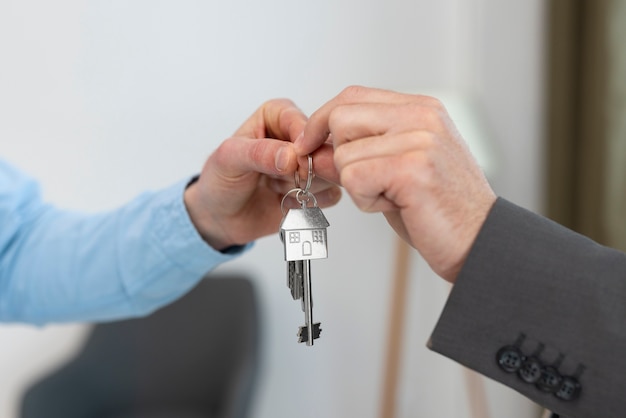 Keys being held by real estate agent and buyer