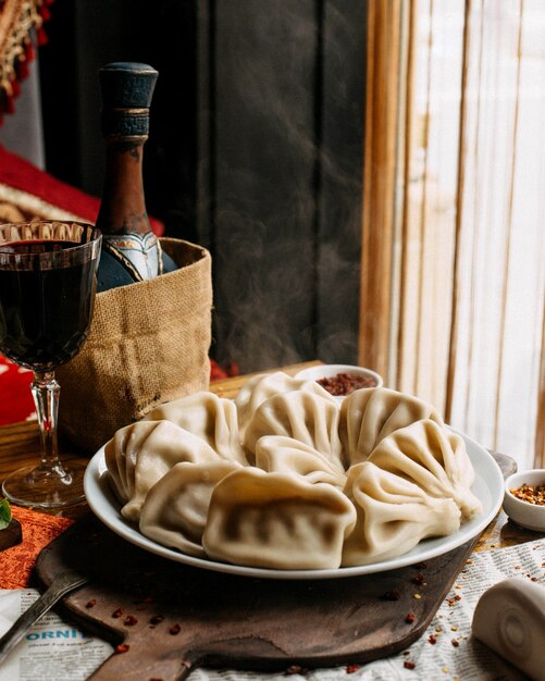 khinkali on plate with glass of red wine