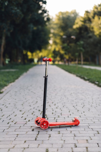 Kick scooter on walkway in the park