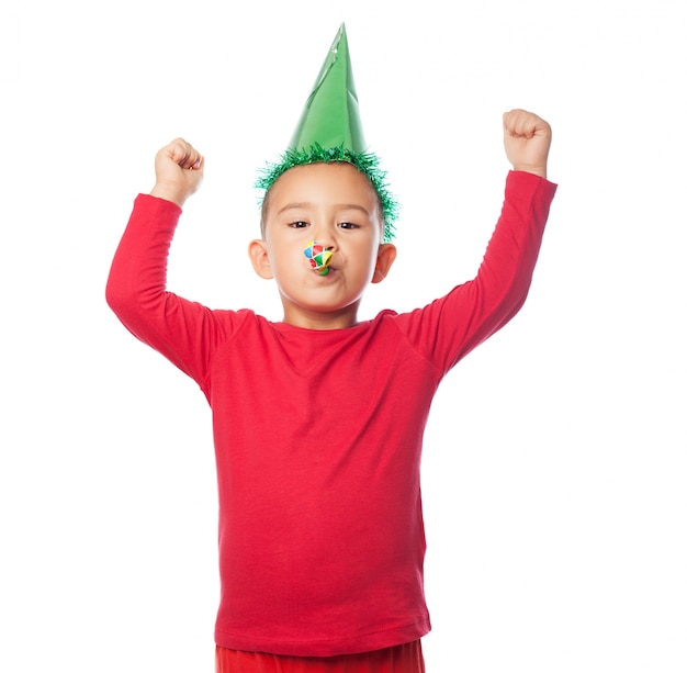 Kid celebrating with a party hat