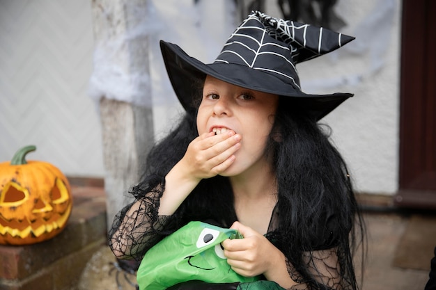 Kid in cute but scary witch costume