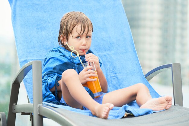 Kid drinking juice after swimming