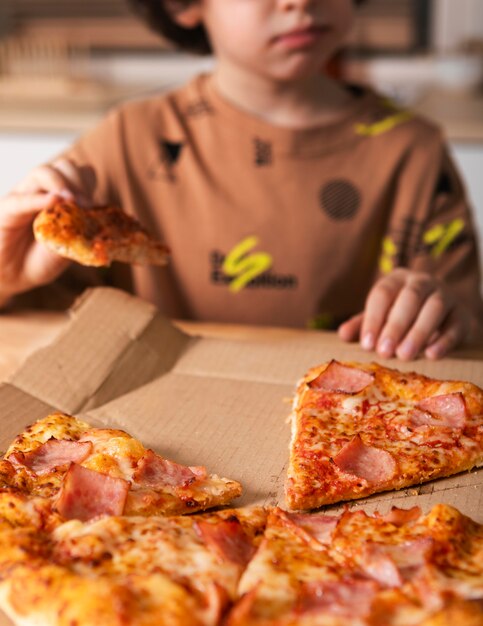 Kid eating pizza at home