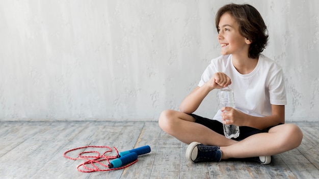 Kid on floor next to jumping rope