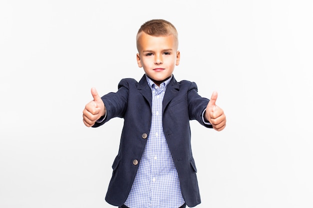 Free photo kid giving thumbs up sign, smiling, isolated on white wall