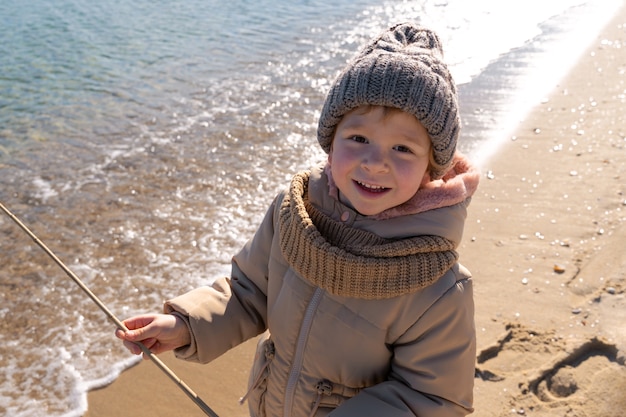 Free photo kid having fun at beach high angle