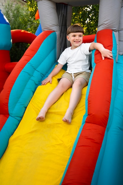 Kid having fun in bounce house side view