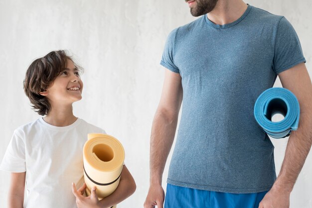 Kid and his father doing sport at home