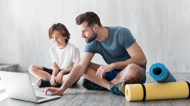 Kid and his father doing sport at home