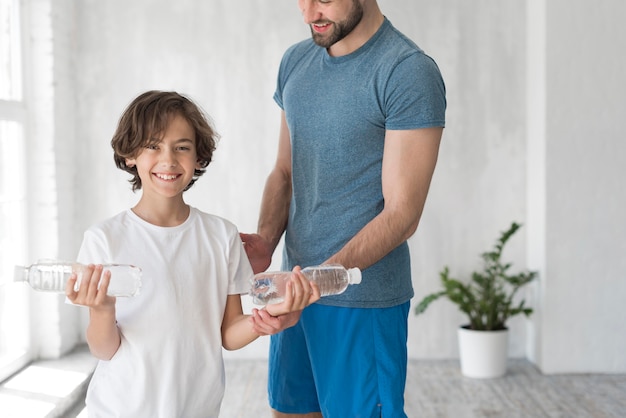 Kid and his father doing sport at home