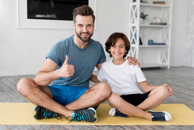 Kid and his father doing sport at home