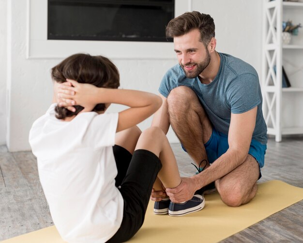 Kid and his father doing sport at home