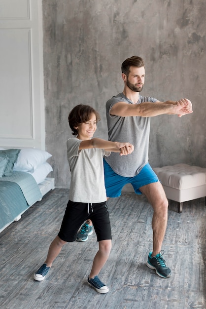 Kid and his father doing sport at home