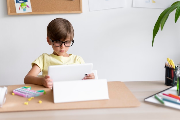 Kid holding tablet medium shot