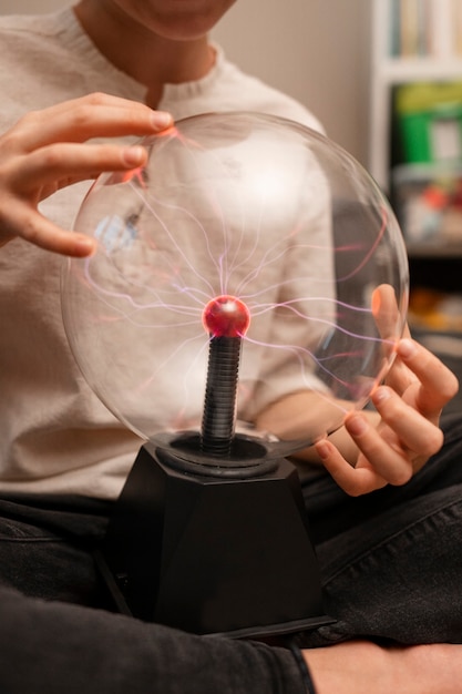 Free Photo kid interacting with a plasma ball