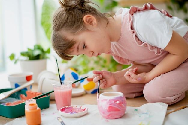 Kid painting plant pot DIY hobby