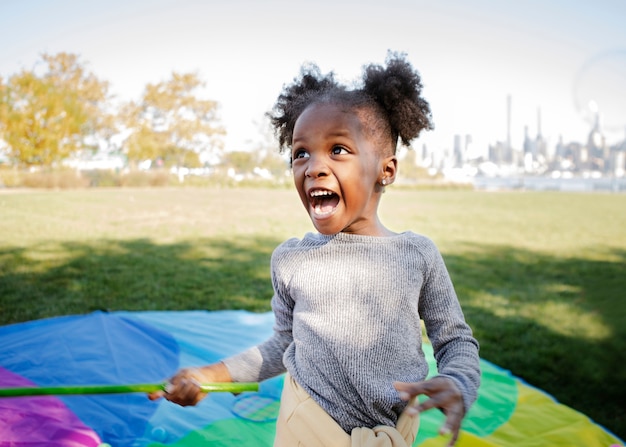 Kid playing outdoorns in the park