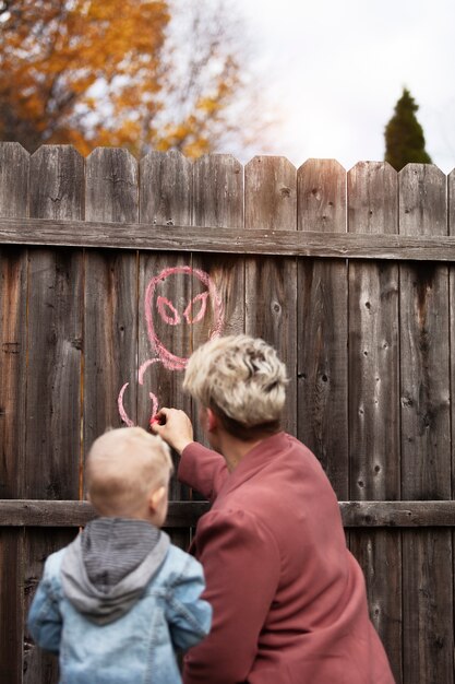 Kid playing outdoors with his mom