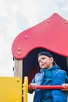 Free photo kid playing outside on playground