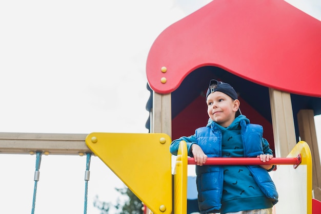 Free photo kid playing outside on playground