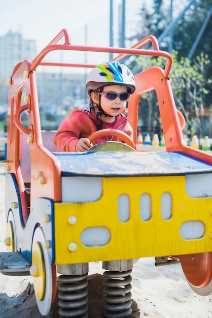 Free photo kid playing outside on playground