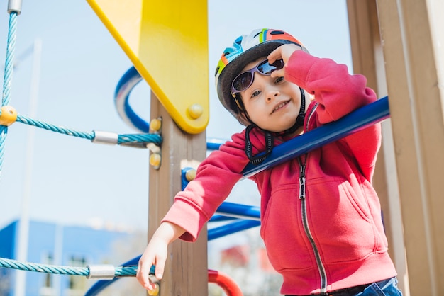 Free photo kid playing outside on playground